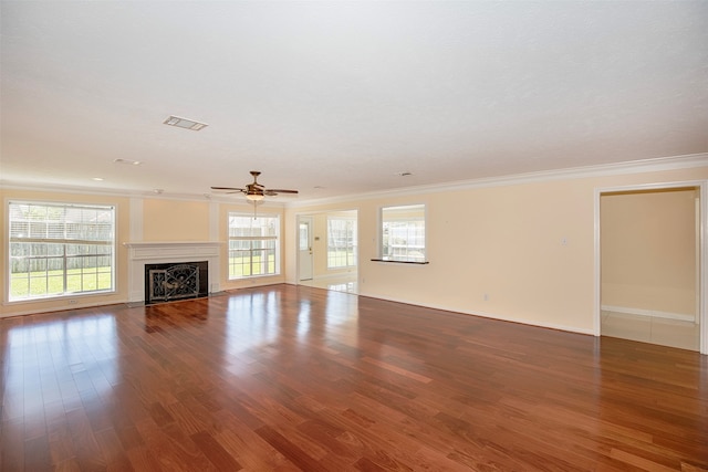 unfurnished living room with ornamental molding, ceiling fan, and dark hardwood / wood-style floors