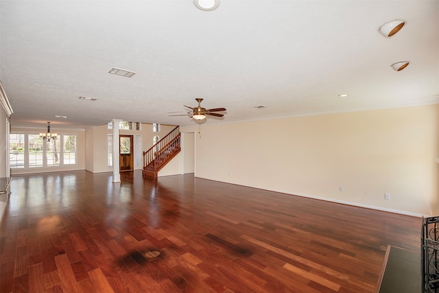 unfurnished living room featuring ceiling fan with notable chandelier, a textured ceiling, dark hardwood / wood-style flooring, and crown molding