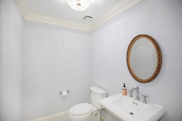 bathroom with sink, toilet, and ornamental molding