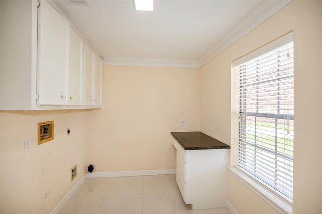 clothes washing area with hookup for an electric dryer, hookup for a washing machine, cabinets, crown molding, and light tile floors