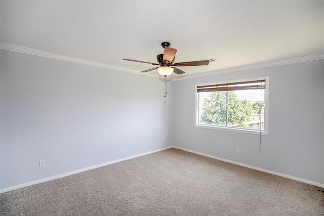 carpeted spare room with ornamental molding and ceiling fan