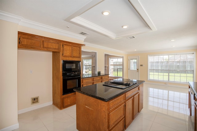 kitchen with a raised ceiling, crown molding, and black appliances