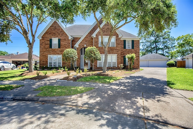 view of front of home with an outdoor structure, a garage, and a front lawn