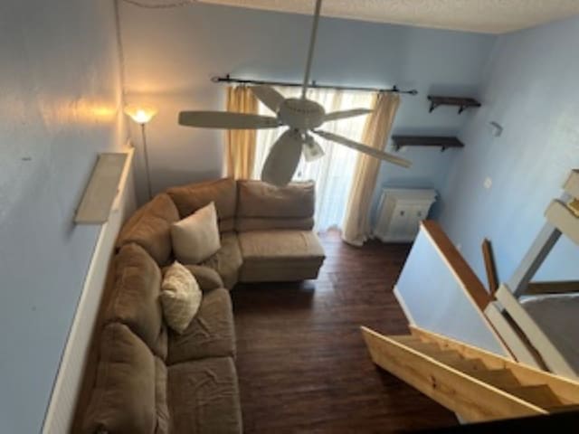 living room featuring dark hardwood / wood-style floors and ceiling fan