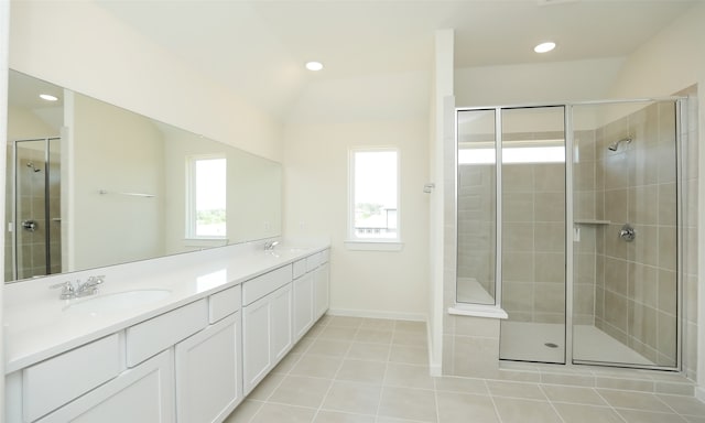 bathroom featuring lofted ceiling, tile patterned floors, walk in shower, and vanity