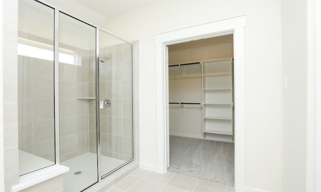 bathroom featuring tile patterned flooring and an enclosed shower