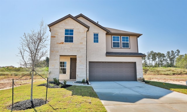 view of front facade featuring a front yard and a garage