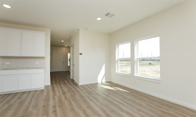 unfurnished living room featuring light wood-type flooring