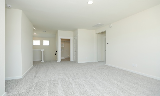 spare room with light colored carpet