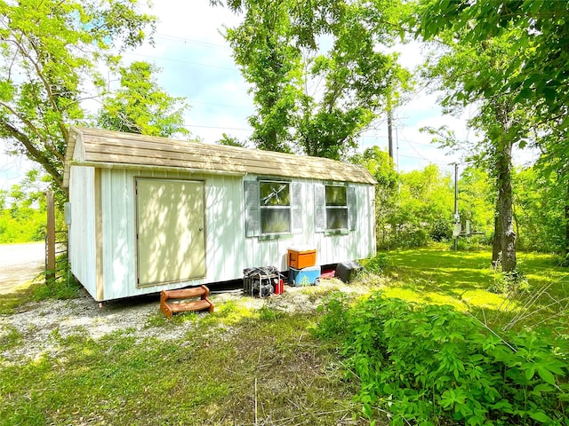 view of outdoor structure with a lawn