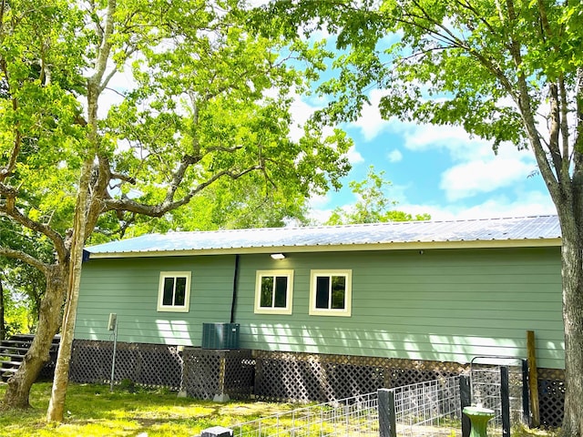 back of house featuring central AC