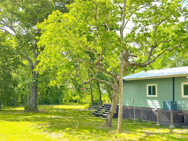 view of yard featuring central air condition unit