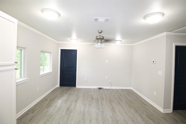 unfurnished room featuring ornamental molding, light hardwood / wood-style floors, ceiling fan, and a textured ceiling