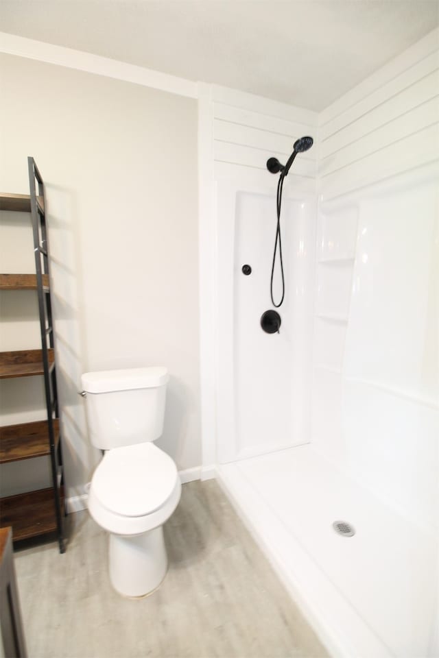 bathroom with walk in shower and toilet