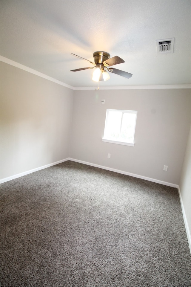 empty room with ornamental molding, carpet, and ceiling fan