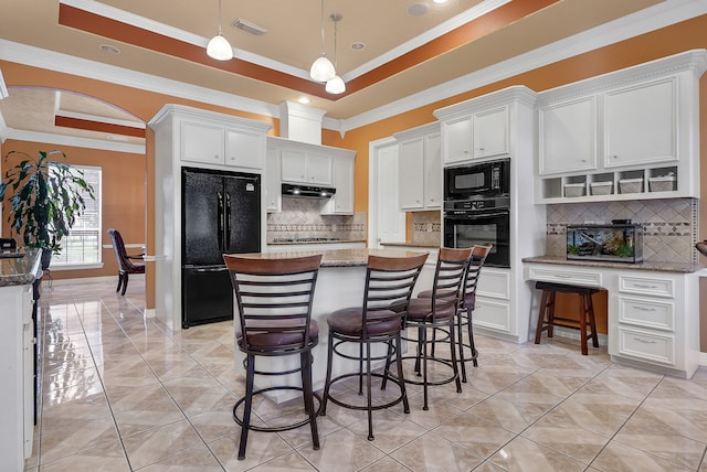 kitchen featuring a kitchen island, white cabinets, tasteful backsplash, hanging light fixtures, and black appliances