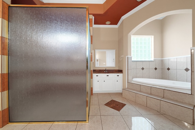 bathroom with ornamental molding, a relaxing tiled bath, vanity, and tile floors