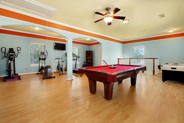 recreation room with light hardwood / wood-style flooring, ceiling fan, crown molding, pool table, and a textured ceiling