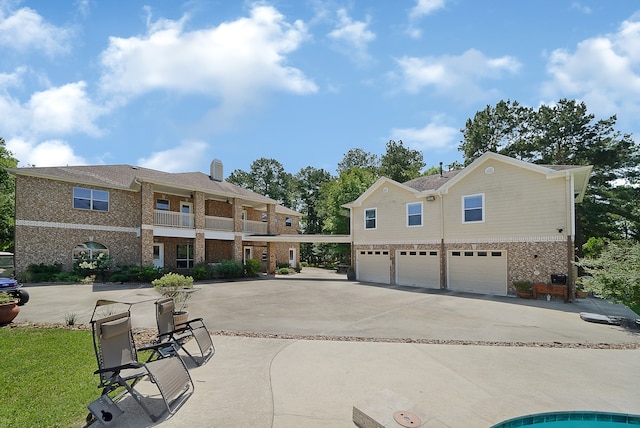 exterior space with a garage and a balcony