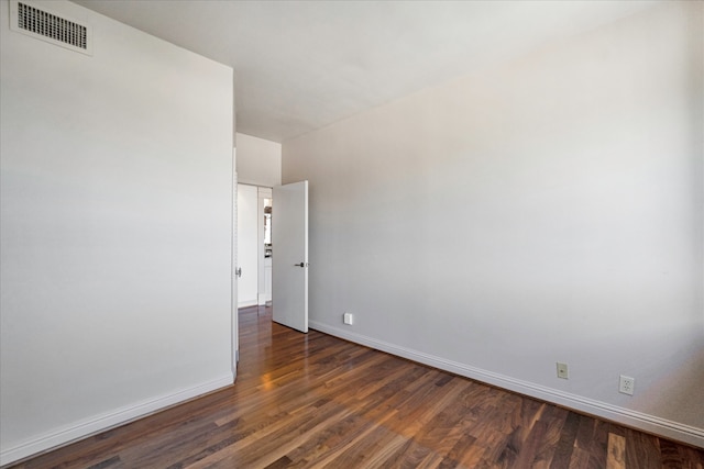 unfurnished room featuring dark hardwood / wood-style flooring