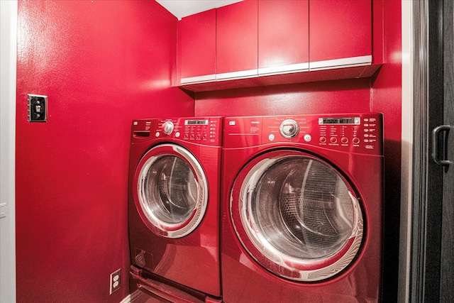 washroom featuring independent washer and dryer and cabinets