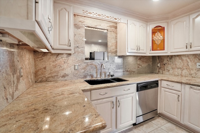 kitchen with dishwasher, light stone countertops, sink, and white cabinets