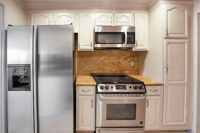 kitchen with tasteful backsplash, stainless steel appliances, and white cabinets