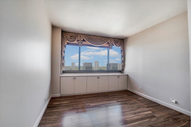 spare room with dark hardwood / wood-style floors