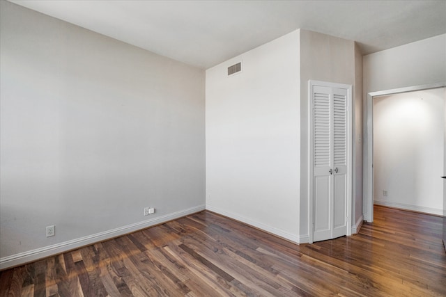 unfurnished bedroom featuring dark wood-type flooring