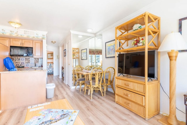 interior space featuring ornamental molding and light hardwood / wood-style floors