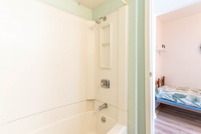 bathroom featuring shower / bath combination and hardwood / wood-style flooring