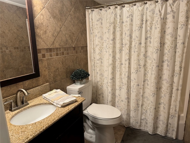 bathroom with tile walls, backsplash, toilet, vanity, and ornamental molding