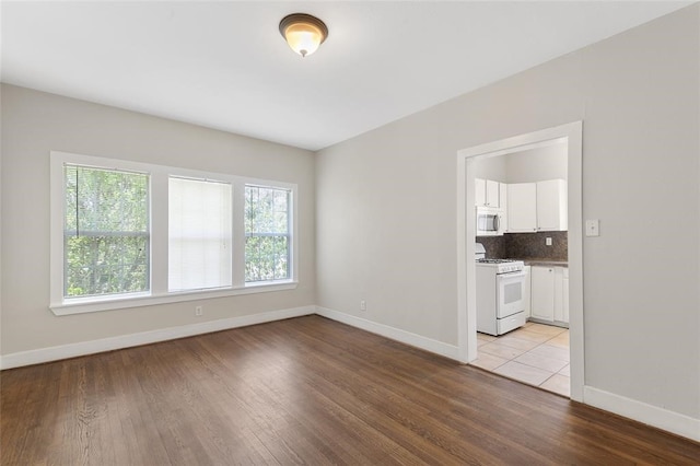 spare room featuring light wood-type flooring