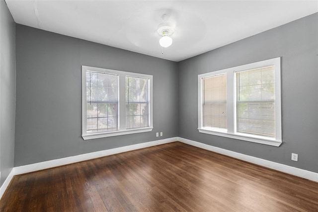 unfurnished room featuring ceiling fan, wood finished floors, and baseboards