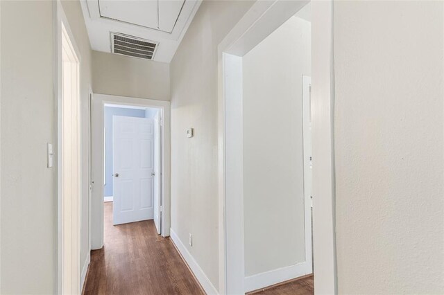 hallway with dark hardwood / wood-style flooring