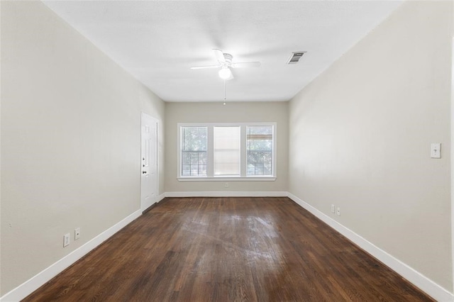 spare room featuring ceiling fan and dark hardwood / wood-style floors