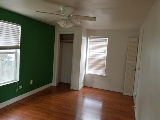 unfurnished bedroom featuring a closet, light hardwood / wood-style flooring, and ceiling fan