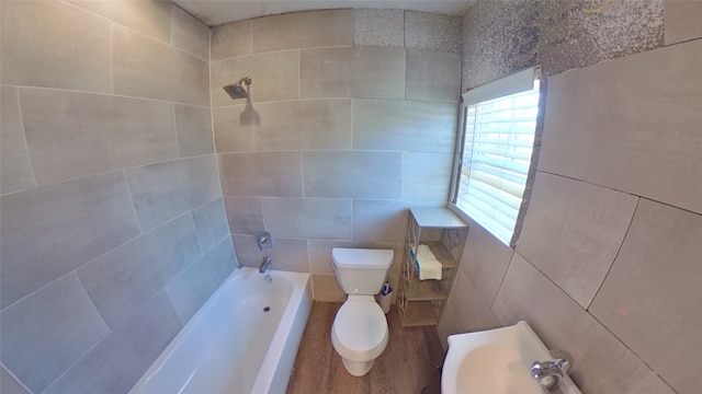 bathroom featuring hardwood / wood-style flooring, toilet, and tile walls