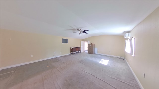 empty room with a wall unit AC, light colored carpet, ceiling fan, and vaulted ceiling