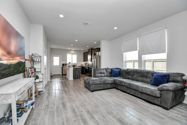 living room featuring light hardwood / wood-style floors and a wealth of natural light