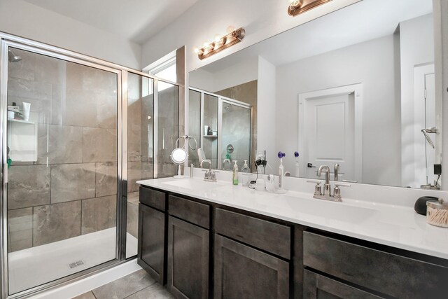 bathroom with tile patterned flooring, vanity, and a shower with door