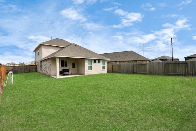 back of property featuring a yard and a patio area