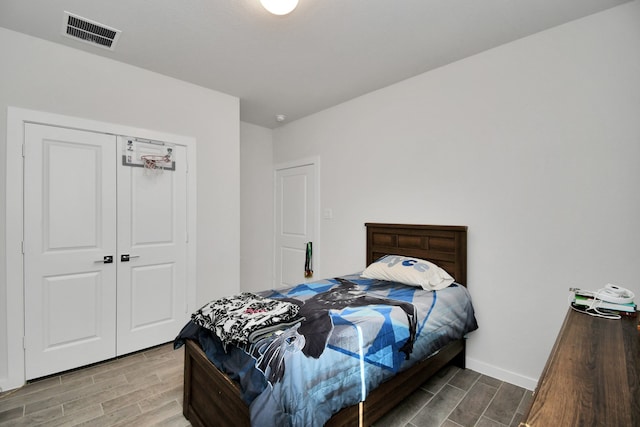 bedroom featuring wood-type flooring and a closet