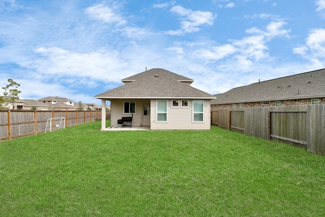 rear view of property featuring a patio area and a lawn