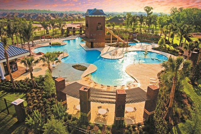 pool at dusk with a patio