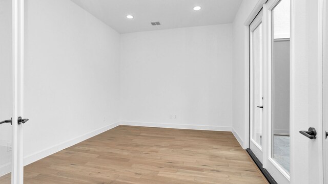 spare room featuring light hardwood / wood-style floors