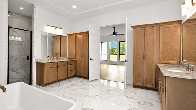 bathroom featuring vanity, hardwood / wood-style flooring, separate shower and tub, and ceiling fan