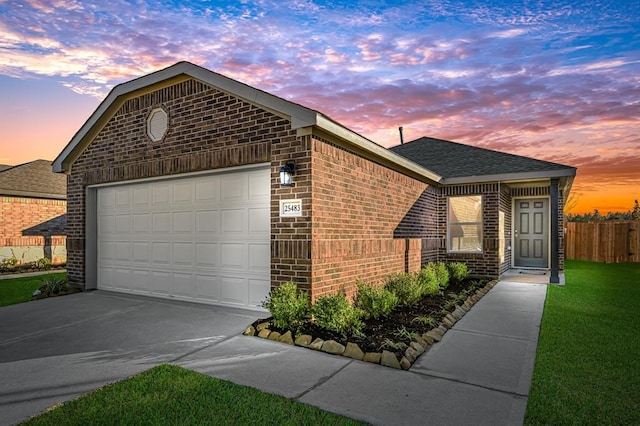 view of front of house with a garage and a lawn