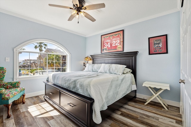 bedroom featuring dark hardwood / wood-style floors, ceiling fan, and crown molding