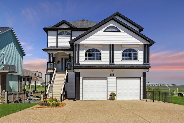 view of front of home featuring central AC and a garage